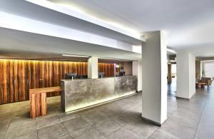 a lobby with a reception desk in a building at Leonardo Royal Hotel Mallorca Palmanova Bay in Palmanova
