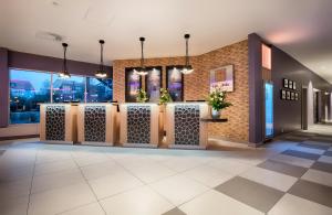 a lobby with a row of doors and windows at Leonardo Hotel Wolfsburg City Center in Wolfsburg