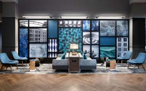 a lobby with a couch and chairs and windows at Sonesta Columbus Downtown in Columbus