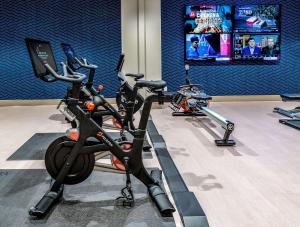 a gym with three exercise bikes parked in a room at Sonesta Columbus Downtown in Columbus