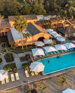 an aerial view of a resort with a pool and umbrellas at La Posada Hotel Boutique in Manzanillo