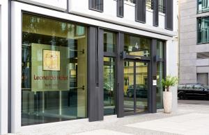 a store front with glass doors on a building at Leonardo Hotel Berlin Mitte in Berlin