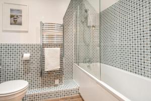 a bathroom with a shower and a toilet and a tub at 2 Bed in Bodham oc-2082 in Bodham +11 photos