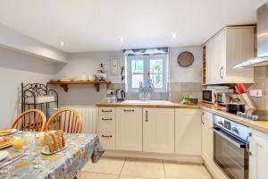 a kitchen with a table and a dining room at 2 Bed in Bodham oc-2082 in Bodham