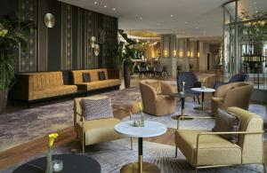a hotel lobby with couches and tables and chairs at Hotel Mannheimer Hof - Leonardo Limited Edition in Mannheim