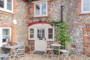 a patio with a table and chairs in front of a building at 2 Bed in Bodham oc-2082 in Bodham