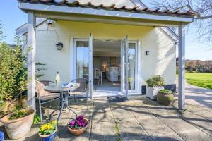a patio of a house with a table and chairs at 1 Bed in Snape oc-sfgcs in Snape