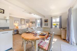 a kitchen and a living room with a table and a couch at 1 Bed in Snape oc-sfgcs in Snape +5 photos