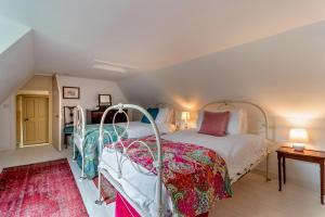 a bedroom with a white bed and a red rug at 4 Bed in Cardross oc-t30303 in Cardross