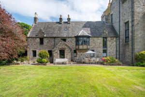 an old stone house with a lawn in front of it at 4 Bed in Cardross oc-t30303 in Cardross