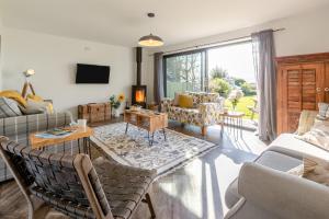 a living room filled with furniture and a large window at 5 Bed in Stibb oc-f31065 in Poughill