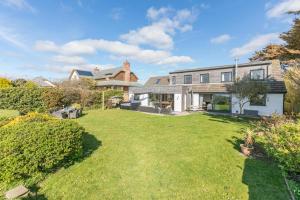 an exterior view of a house with a large yard at 5 Bed in Stibb oc-f31065 in Poughill