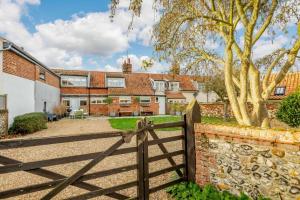 a gate in front of a house with a fence at 3 Bed in Brancaster oc-h27159 in Brancaster