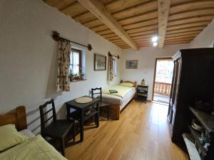 a bedroom with a bed and a desk and a table at Füstös Cottage Gömörszőlős in Gömörszőlős