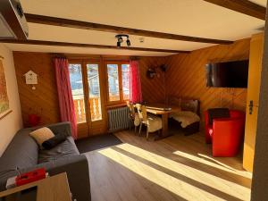 a living room with a couch and a table at Alte Bock 2.0 in Grächen