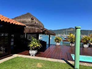 a resort with a deck with a view of the water at Casa do Abrahão in Angra dos Reis