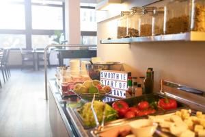 a buffet line with fruits and vegetables on display at Leonardo Hotel Utrecht City Center in Utrecht