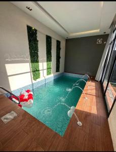 a swimming pool in the middle of a room at شاليهات سمو بارك in Taif