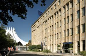 a large building with a flag on top of it at The Posthouse Berlin Potsdamer Platz- Leonardo Limited Edition in Berlin