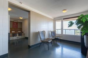 a waiting room with three chairs and a window at Leonardo Hotel IJmuiden Seaport Beach in IJmuiden