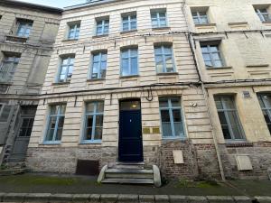 an old stone building with a blue door at Les Toits d'Arras in Arras +3 photos