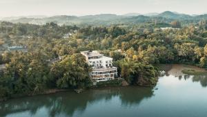 an aerial view of a house on an island in a lake at Royal Avenue Kandy in Kandy
