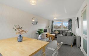 a living room with a vase of flowers on a table at Central Upton Upon Severn 2 bedroom property sleeps 6 in Upton upon Severn