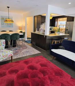 a living room with a red rug and a kitchen at Private Bedroom with Ensuite in Toronto