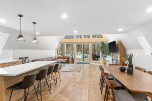 a kitchen and living room with tables and chairs at The Dream House Retreat in Necedah