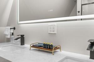a bathroom with a sink and a shelf with bottles on it at The Dream House Retreat in Necedah +60 photos