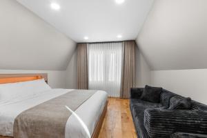 a bedroom with a bed and a couch at The Dream House Retreat in Necedah