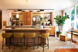 a kitchen with a large island with bar stools at Jan Luyken Amsterdam in Amsterdam