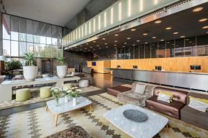 a lobby with a couch and a table at Leonardo Royal Hotel Barcelona Forum in Barcelona
