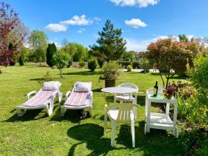 a group of chairs and a table in the grass at St Pasha in Paillé