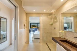 a bathroom with a shower and a bed in a room at Hotel Cala Lunga in La Maddalena +232 photos