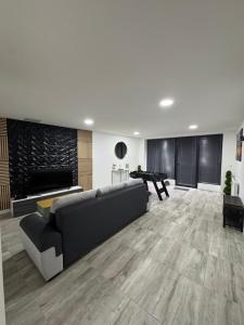 a large living room with a couch and a piano at La Suite Mirebalaise in Poitiers +4 photos