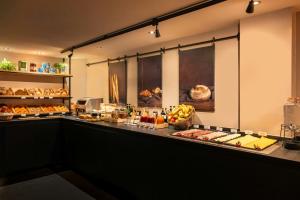 a buffet line with many different types of food at Leonardo Boutique Hotel Maastricht City Center in Maastricht +39 photos