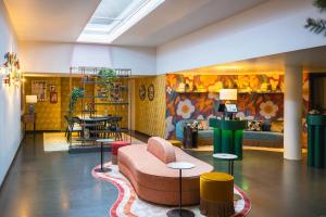 a lobby with a couch and a table at Leonardo Boutique Hotel Maastricht City Center in Maastricht