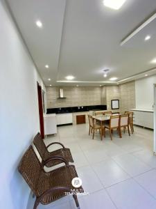 a dining room with a table and some chairs at Casa Aconchego Barra Velha/SC in Barra Velha