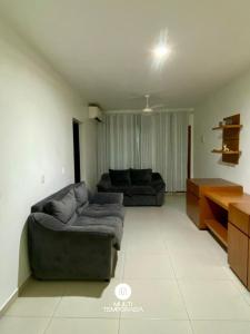a living room with a couch and a table at Casa Aconchego Barra Velha/SC in Barra Velha