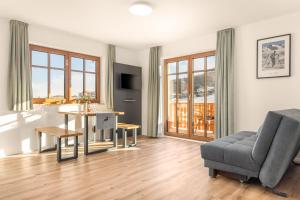 a living room with a couch and a table at Alpen Lodge Samerberg in Samerberg +23 photos