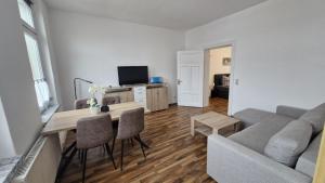 a living room with a couch and a table with chairs at Inselglück in Malchow