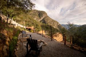 two chairs sitting on a hill with a view at DM El Refugio SG Af3 in Pinal de Amoles +65 photos