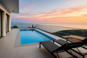 a swimming pool on the balcony of a house at Half Gate Villa - Ocean View & Private Pool in Gaula