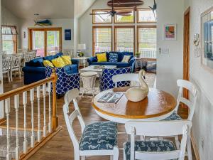 a living room with a table and chairs at Raspberry Duck - Duck Landing, 525 Yds to Beach, Pool, Tiki Bar, Hot Tub, Close to Downtown in Duck +53 photos