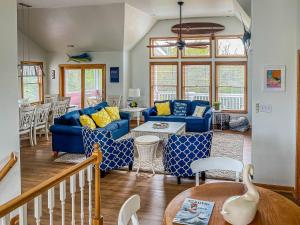 a living room with blue couches and a table at Raspberry Duck - Duck Landing, 525 Yds to Beach, Pool, Tiki Bar, Hot Tub, Close to Downtown in Duck