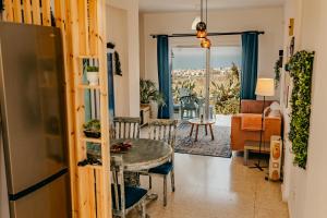 a living room with a table and a couch at Two Bedroom Sea View Townhouse-Villa Libellula in Khlorakas