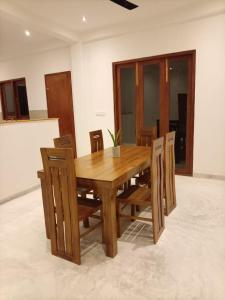 a wooden dining table and chairs in a room at Villa Nimāmi in Ahangama +13 photos
