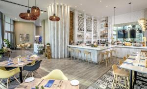 a restaurant with tables and chairs and a bar at Oceanfront Lyfe Resort in Hollywood