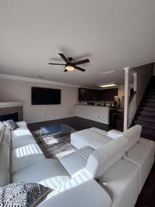 a living room with white couches and a ceiling fan at 5bd Beautiful Modern home in Spring in Spring